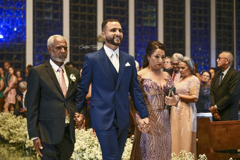 Groom's processional with parents - father and mother walking him down church aisle