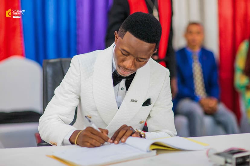 Groom signing wedding documents