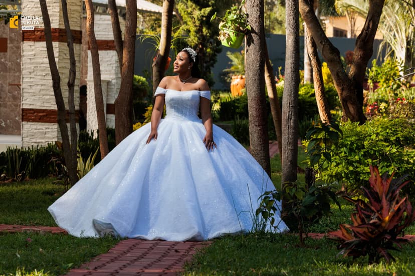 Elegant bridal portrait in sparkly white ball gown in garden setting