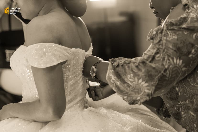 Black and white artistic shot of bride getting bracelet during preparation
