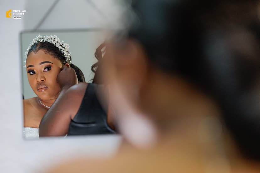 Bride looking in mirror during preparation with beautiful tiara