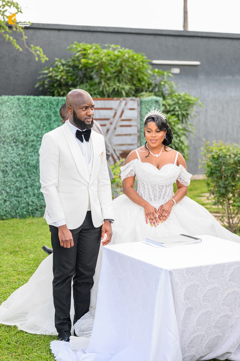 Bride and groom at ceremony signing table in garden setting