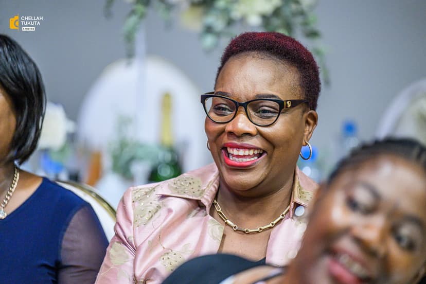 Laughing wedding guest with glasses in pink outfit